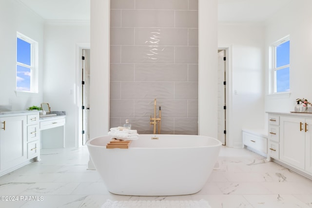 bathroom with a tub, crown molding, vanity, and a healthy amount of sunlight