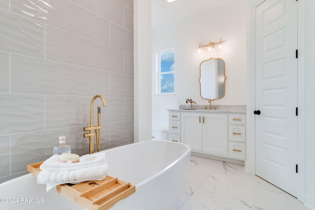 bathroom with a bathing tub, vanity, and tile walls