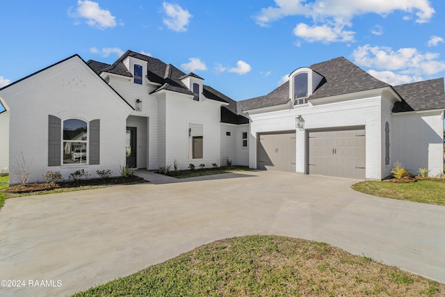 french country home with a garage