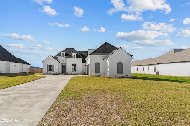 french country style house with a front lawn