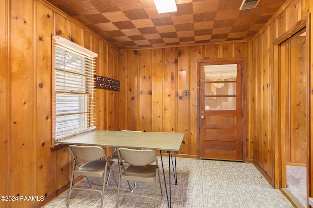 dining area featuring wood walls