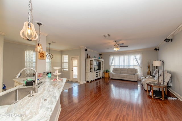 living room featuring crown molding, dark hardwood / wood-style floors, sink, and ceiling fan