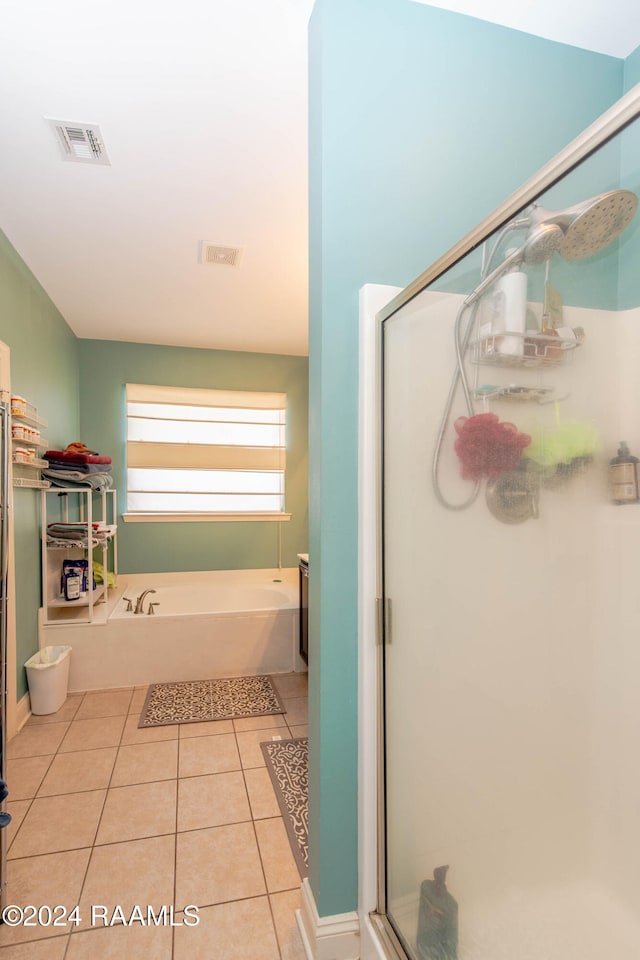 bathroom with separate shower and tub and tile patterned flooring