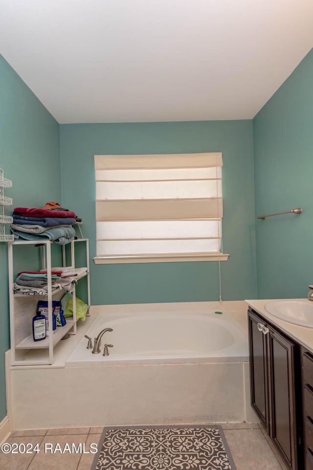 bathroom with vanity, a bathtub, and tile patterned floors