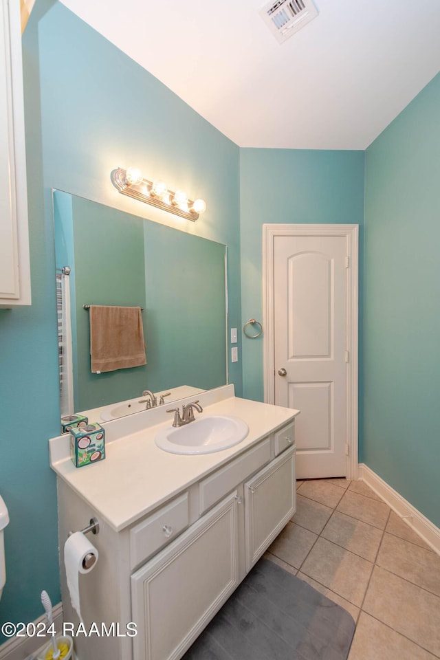 bathroom with vanity, toilet, and tile patterned floors