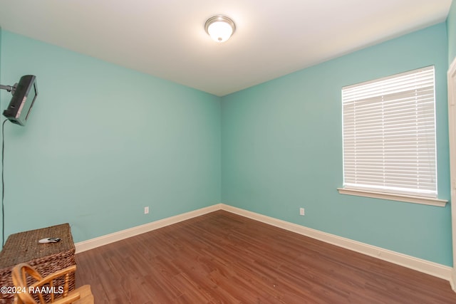 empty room with dark wood-type flooring