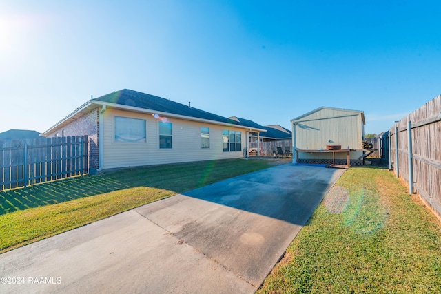 back of property featuring a yard and a patio