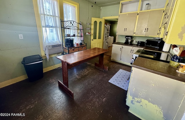 510 S Adams St, Welsh, LA 70591 - kitchen with dark countertops, cooling unit, and black appliances