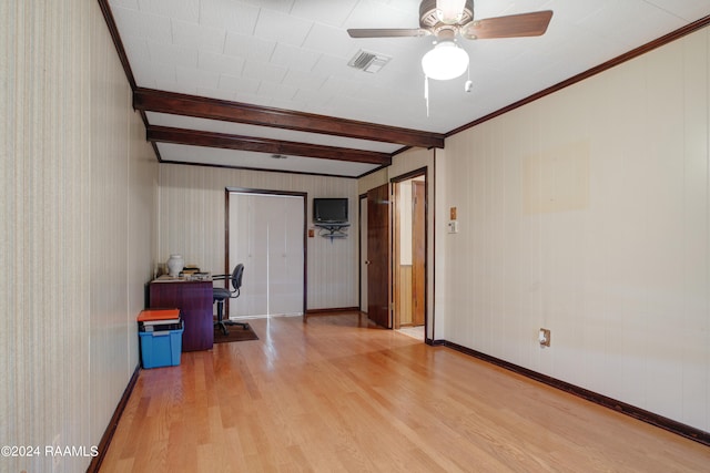 spare room with crown molding, beamed ceiling, light wood-type flooring, and ceiling fan