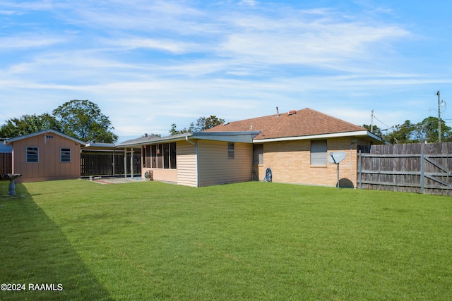 rear view of property with a sunroom and a lawn