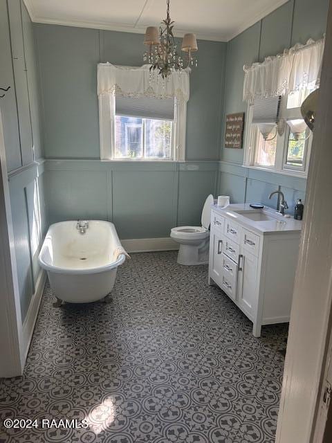 bathroom featuring vanity, a bathing tub, toilet, and plenty of natural light