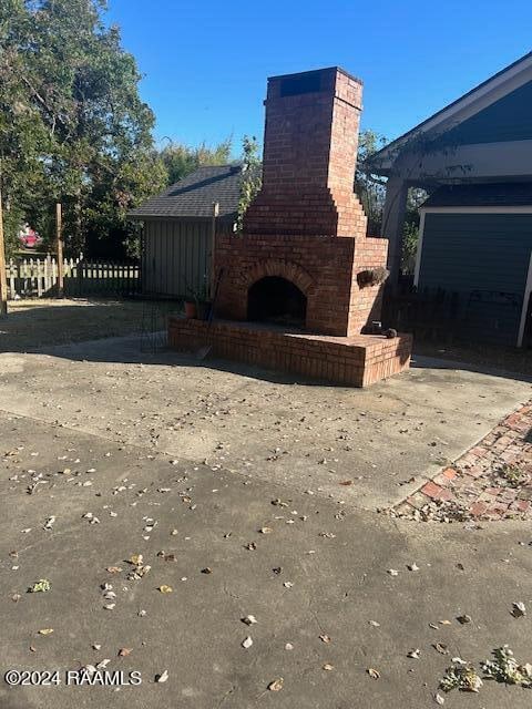 exterior space with an outdoor brick fireplace