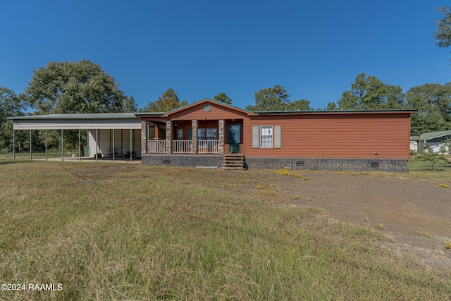 view of front of home with a porch, a front lawn, and a carport