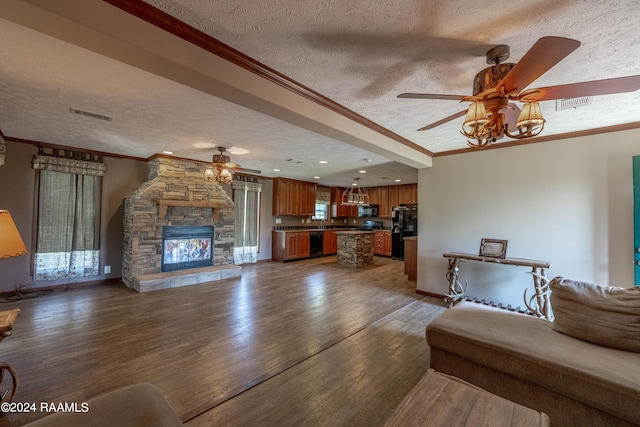 unfurnished living room with a stone fireplace, a textured ceiling, ceiling fan, and dark hardwood / wood-style floors