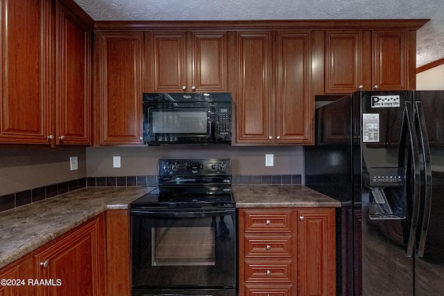 kitchen with a textured ceiling, black appliances, and stone countertops