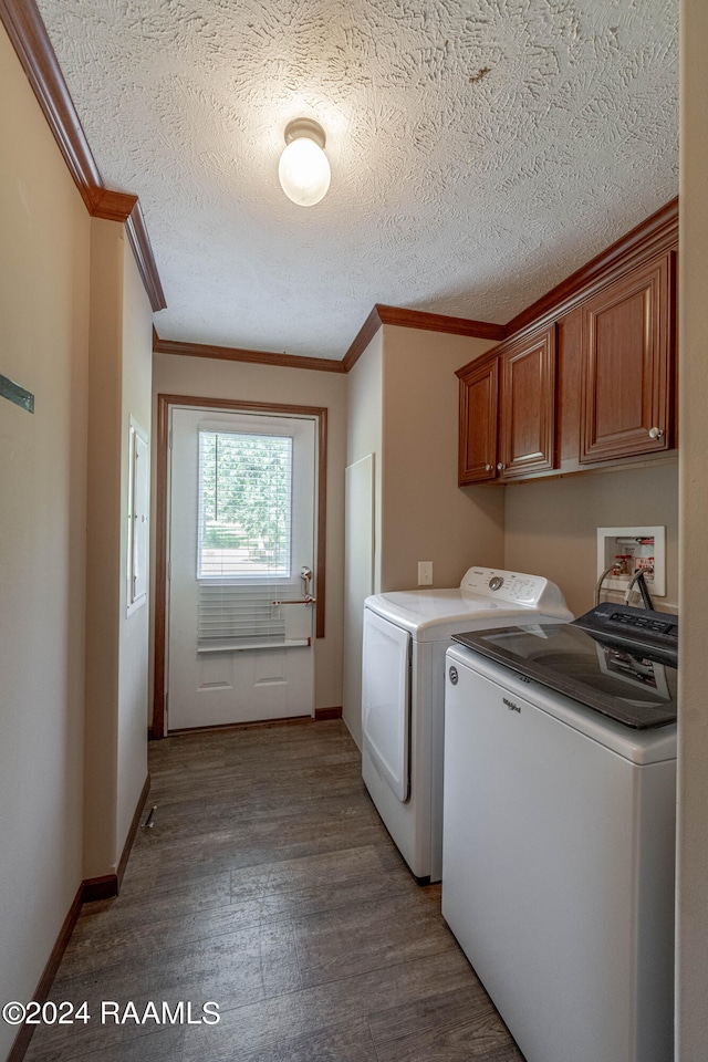 clothes washing area featuring independent washer and dryer, wood-type flooring, ornamental molding, cabinets, and a textured ceiling