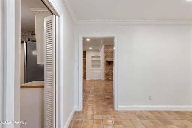 corridor featuring ornamental molding, brick wall, and built in shelves