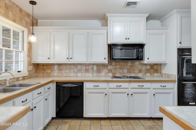 kitchen featuring tasteful backsplash, black appliances, sink, hanging light fixtures, and white cabinets