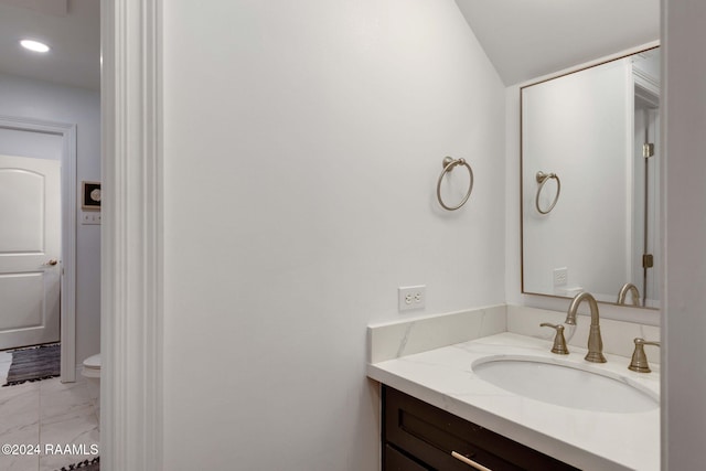 bathroom with vanity and toilet