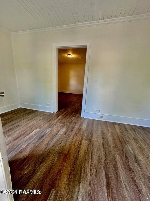 unfurnished room featuring ornamental molding and hardwood / wood-style floors