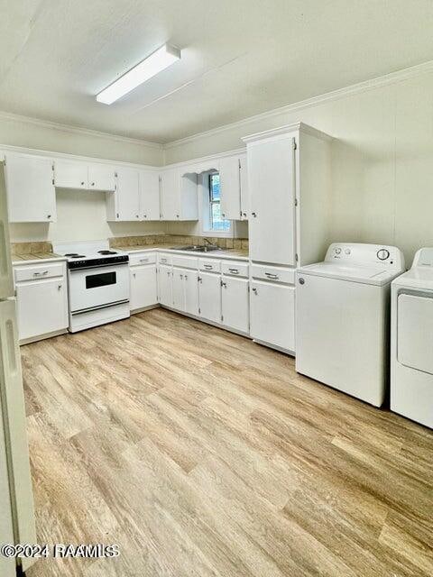 kitchen featuring white cabinetry, separate washer and dryer, light hardwood / wood-style floors, crown molding, and white range