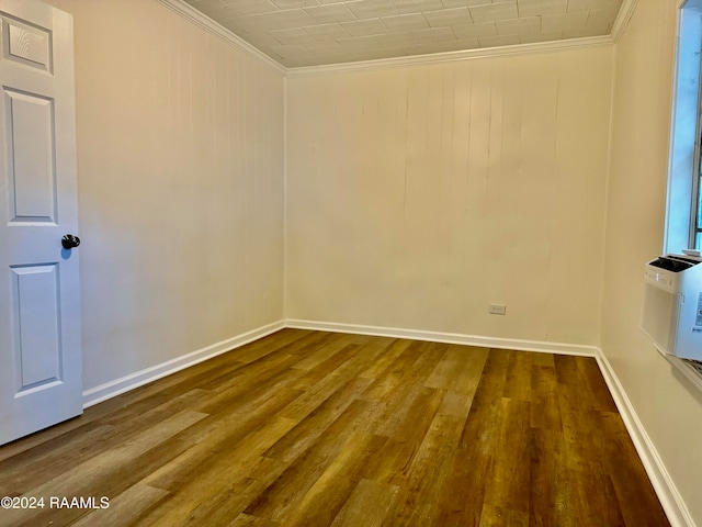 empty room featuring ornamental molding and dark hardwood / wood-style flooring