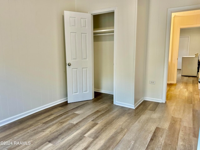 unfurnished bedroom featuring a closet and light wood-type flooring