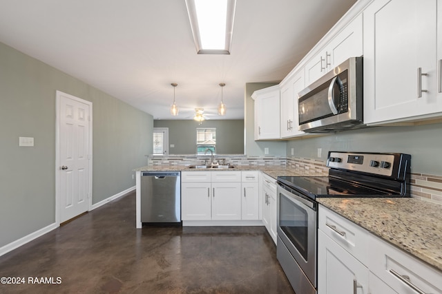 kitchen with stainless steel appliances, hanging light fixtures, sink, backsplash, and white cabinetry