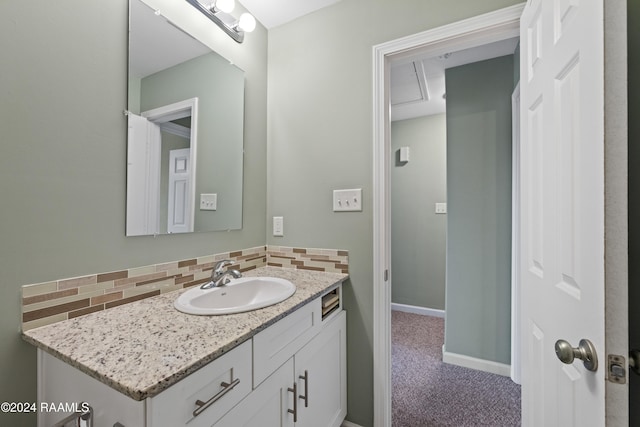 bathroom featuring tasteful backsplash and vanity