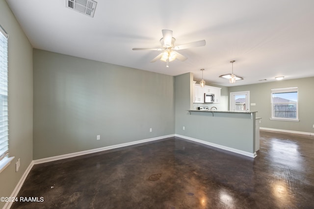 unfurnished living room featuring ceiling fan