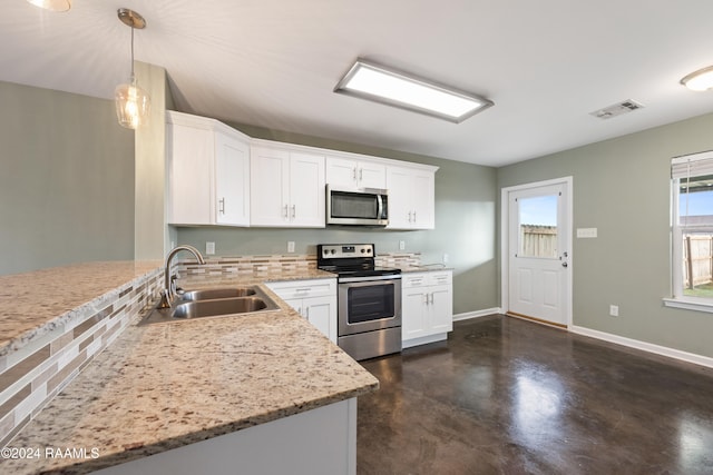 kitchen featuring stainless steel appliances, sink, light stone counters, white cabinets, and pendant lighting