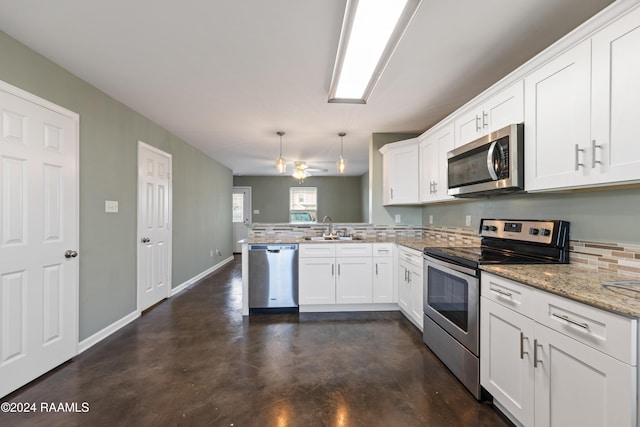 kitchen featuring stainless steel appliances, white cabinetry, sink, kitchen peninsula, and hanging light fixtures