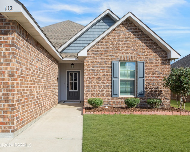 doorway to property with a yard