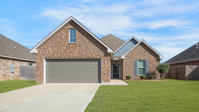 view of front property featuring a front lawn and a garage