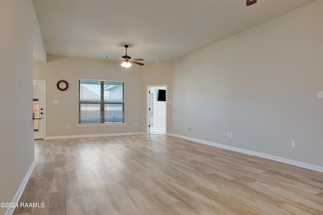 spare room with light wood-type flooring and ceiling fan