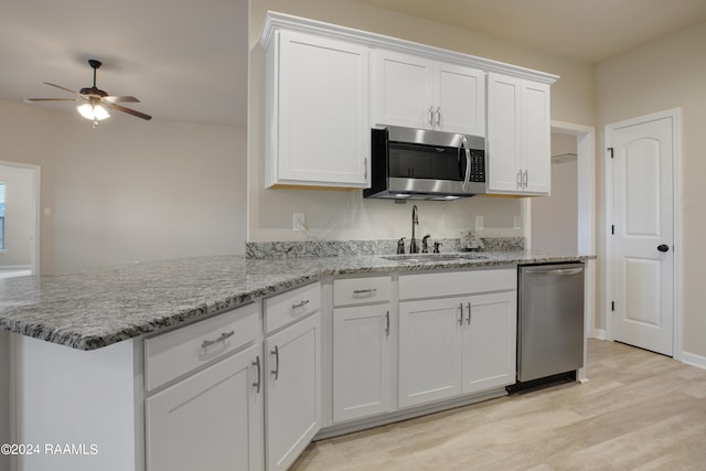 kitchen with white cabinets, stainless steel appliances, and sink