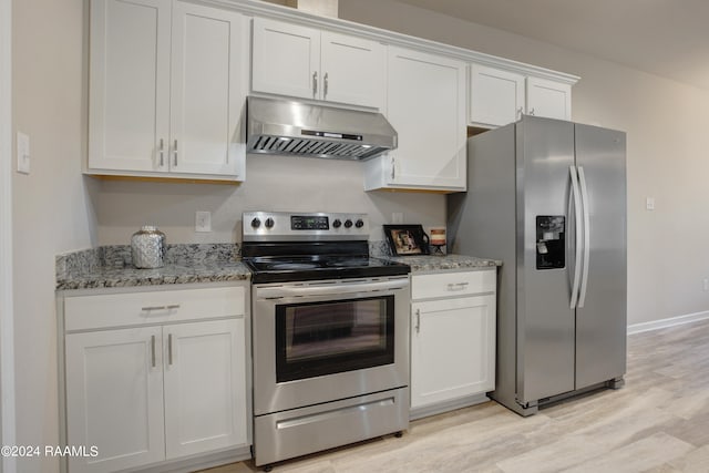 kitchen featuring light stone counters, stainless steel appliances, light hardwood / wood-style flooring, and white cabinets