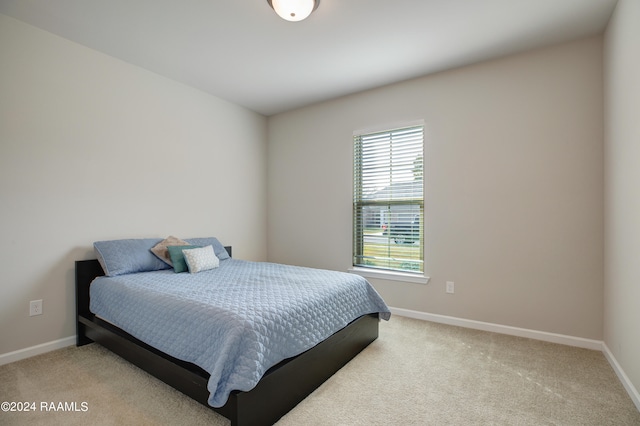 bedroom featuring light carpet