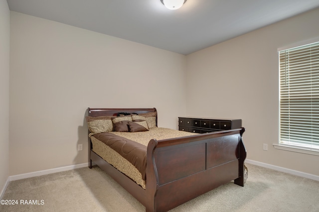 bedroom featuring light colored carpet