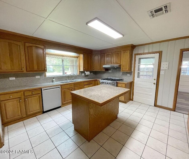 kitchen with a center island, light tile patterned floors, sink, and appliances with stainless steel finishes