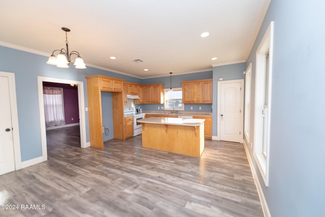 kitchen with a kitchen island, white electric range oven, wood-type flooring, crown molding, and decorative light fixtures