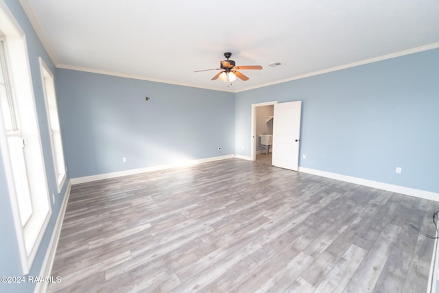 empty room featuring ornamental molding, hardwood / wood-style flooring, and ceiling fan