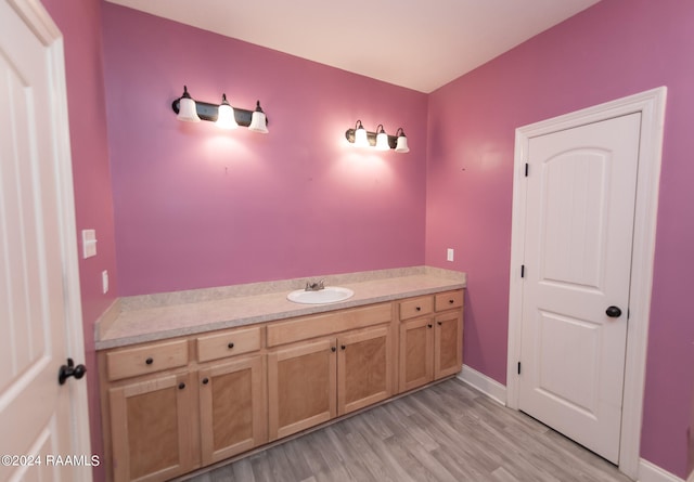 bathroom with vanity and hardwood / wood-style floors