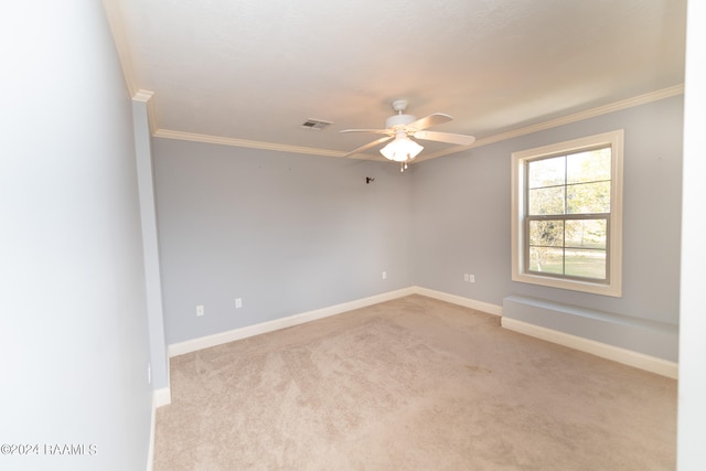 unfurnished room with ornamental molding, light colored carpet, and ceiling fan