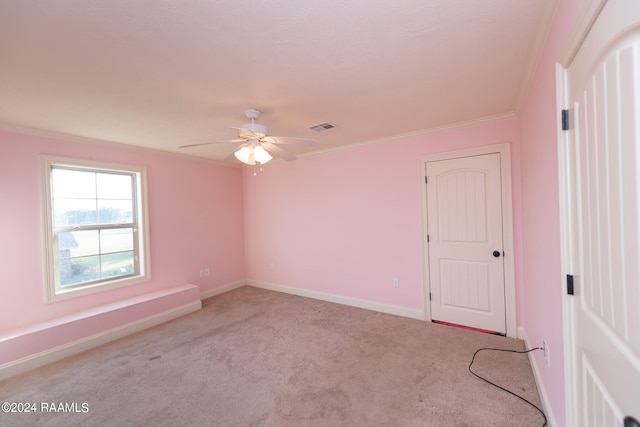 unfurnished room with ornamental molding, light carpet, and ceiling fan