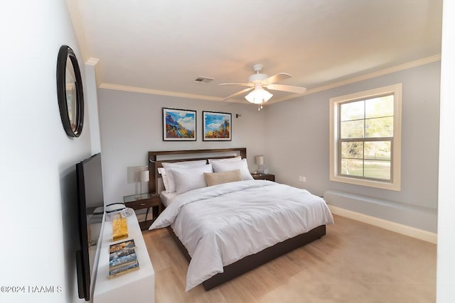 bedroom with crown molding, light carpet, and ceiling fan