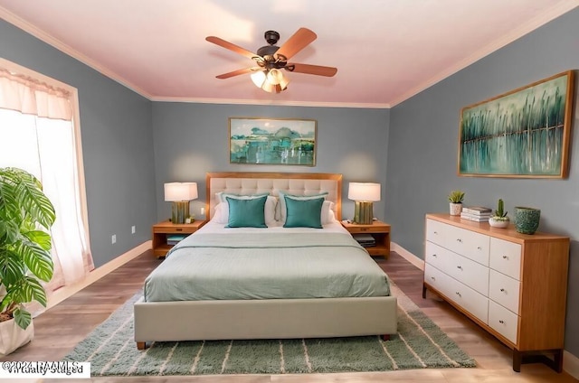 bedroom featuring crown molding, hardwood / wood-style flooring, and ceiling fan