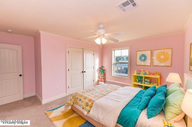 bedroom featuring a closet, light colored carpet, crown molding, and ceiling fan