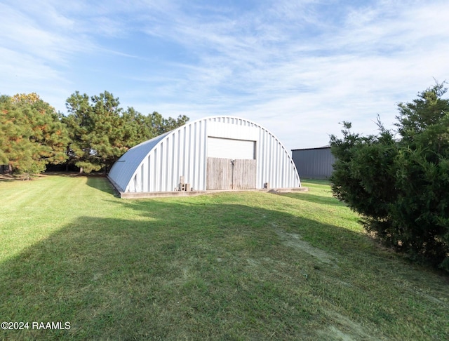 view of outbuilding featuring a lawn