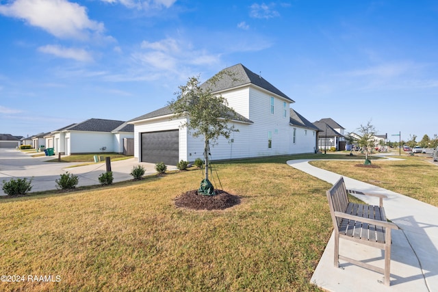 view of side of home featuring a yard and a garage